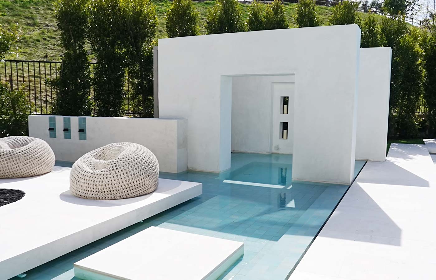 Un piscina con rivestimenti di colore bianco con grandi sedute